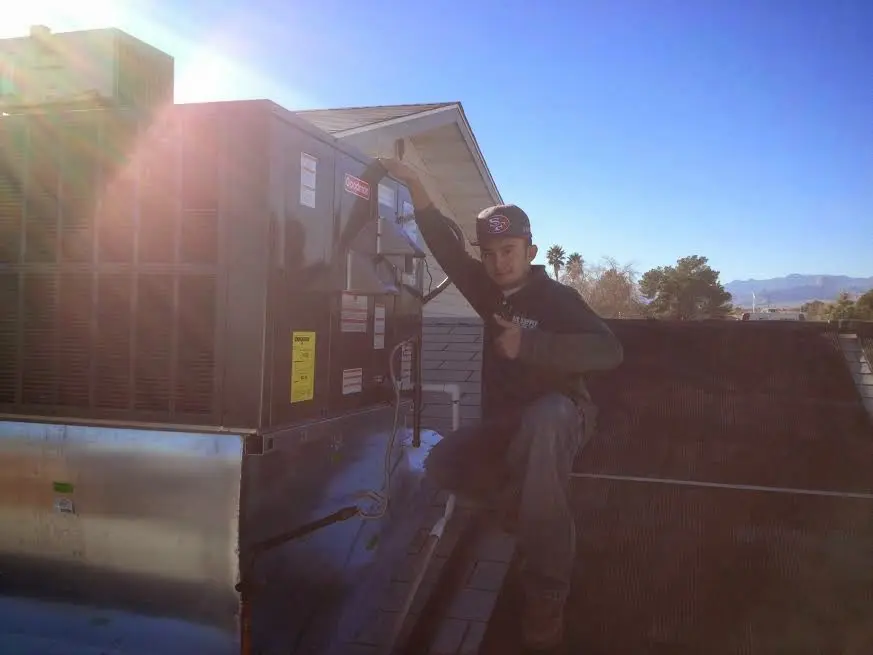 HVAC technician performing HVAC Inspection on a rooftop unit in Aledo